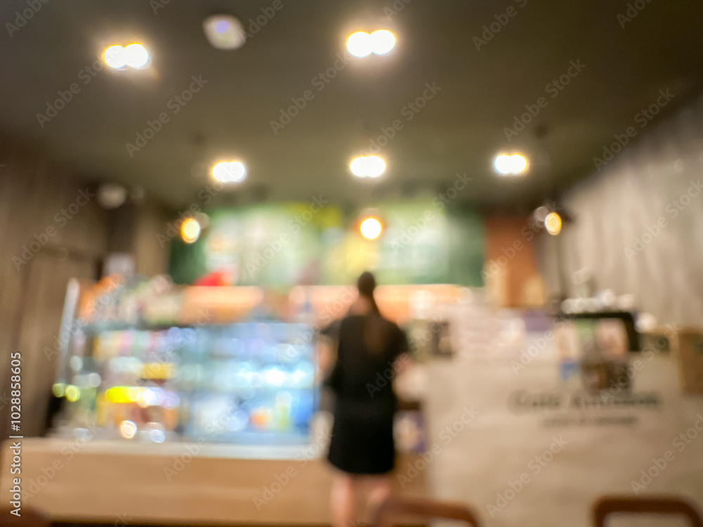 Obraz premium Blurred Coffee Shop Interior with Warm Lighting