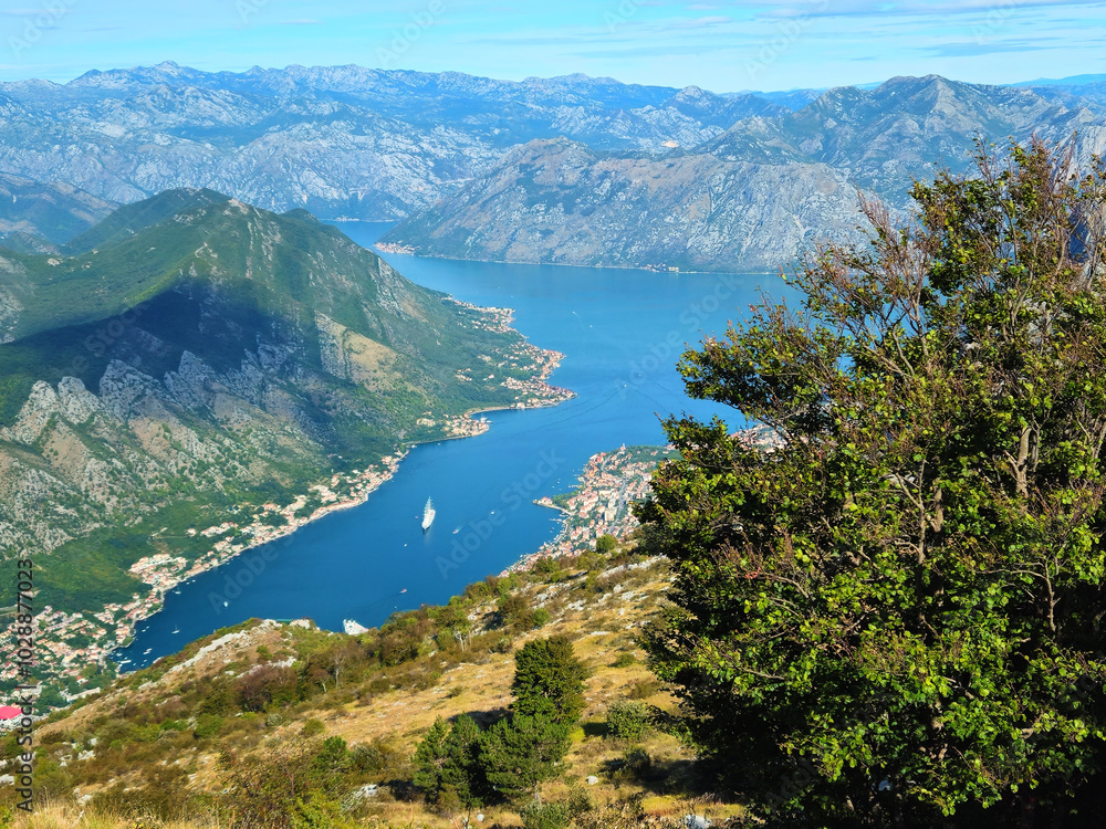 Horizontal aerial view of the Bay of Kotor in Montenegro, surrounded by mountains, coastal towns, and blue water, with copy space in the sky. Ideal for travel promotions or social media backgrounds. Horizontal aerial view of the Bay of Kotor in Montenegro, surrounded by mountains, coastal towns, and blue water, with copy space in the sky. Ideal for travel promotions or social media backgrounds.