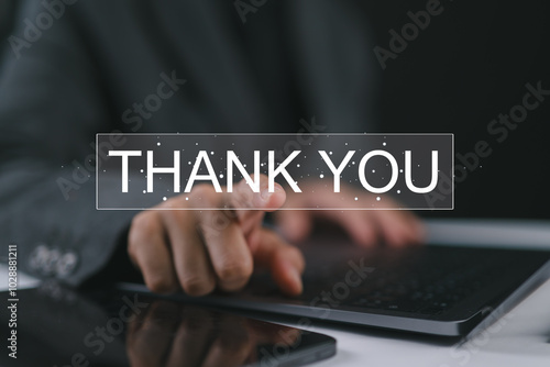 Businesswoman using a laptop and touching the message thank you on a display screen. Concept of thank you business, congratulations, and appreciation gratitude. Presentation from technology digital.