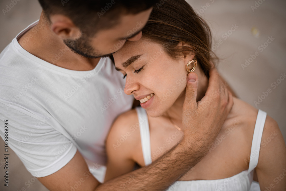 Close-up of young woman and man in love, smiling bride closes her eyes with pleasure and leans her head on his shoulder Close-up of young woman and man in love, smiling bride closes her eyes with pleasure and leans her head on his shoulder