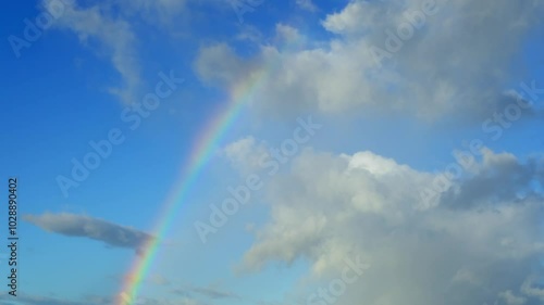 Vanishing rainbow in the sky after rain. Time lapse video of a natural phenomenon when the sunlight. Sunlight splits into different colored rays because of moisture droplets in the air. photo