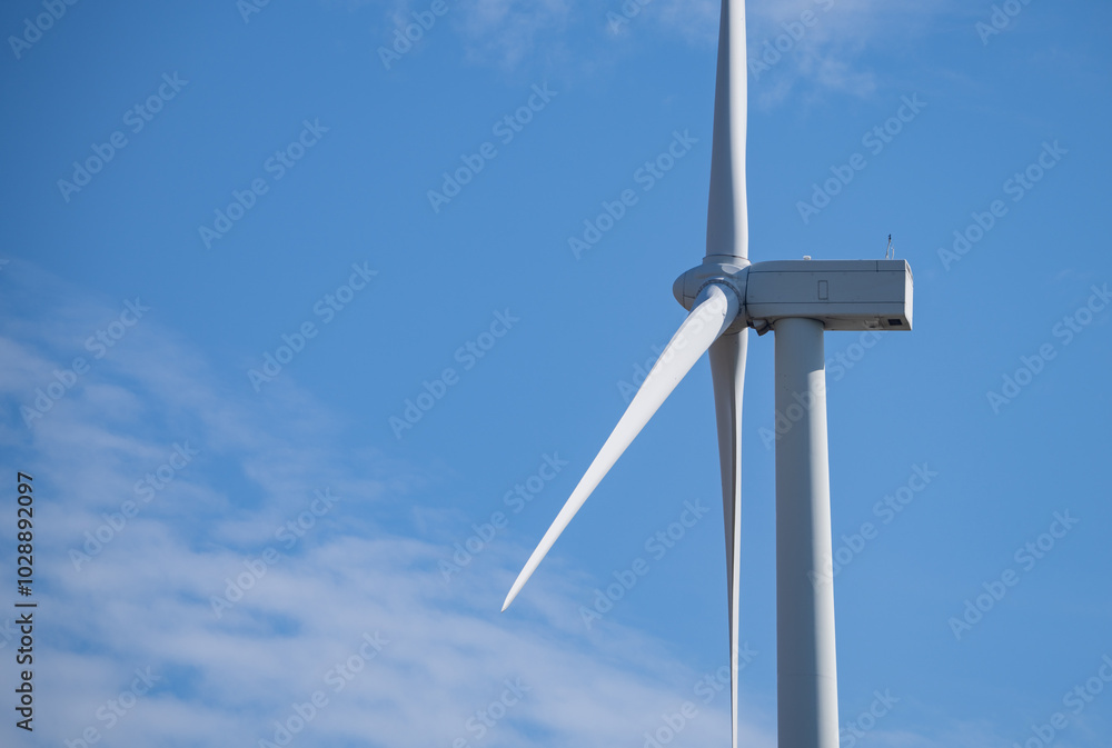 Wind turbines against blue sky, Wind energy. Wind power. Sustainable, renewable energy. Wind turbine generate electricity. Sustainable resources. Green technology for energy sustainability. Wind turbines against blue sky, Wind energy. Wind power. Sustainable, renewable energy. Wind turbine generate electricity. Sustainable resources. Green technology for energy sustainability.