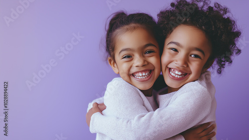 National Siblings Day Love. Two smiling siblings hugging in front of a soft purple background