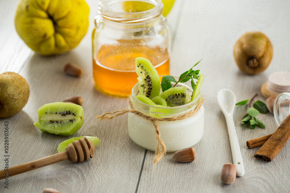 Homemade yogurt in a glass jar with honey, kiwi, nuts. Homemade yogurt in a glass jar with honey, kiwi, nuts.