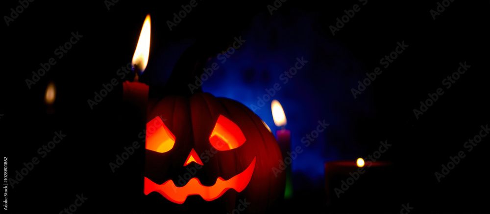 Fototapeta premium glowing jack-o-lantern with candles