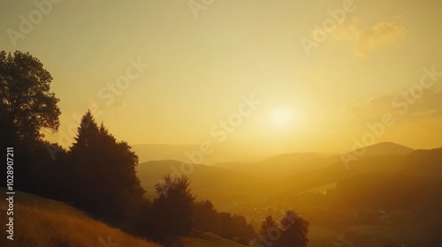 A picturesque sunset over a mountain range, with rolling hills and a golden sky.