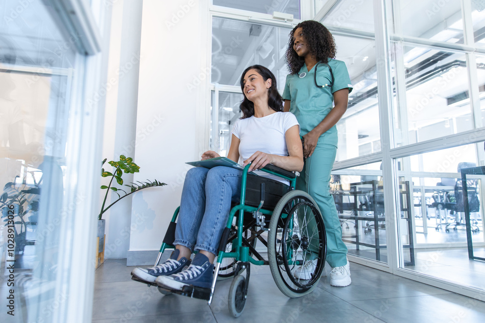 African american female doctor with a patient in a wheelchair in the clinic corridor African american female doctor with a patient in a wheelchair in the clinic corridor