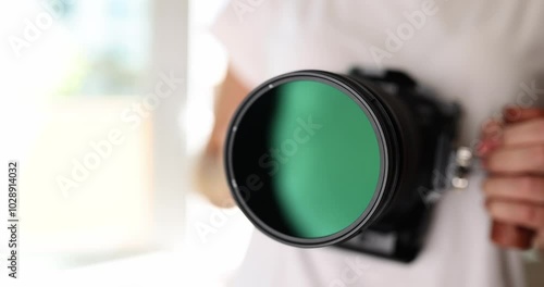 Professional digital camera in female hand closeup. Profession photojournalist concept