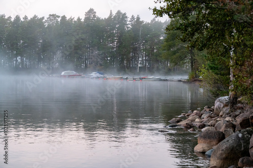 Morning fog over boat jetty in Vastanvik Motala Sweden photo