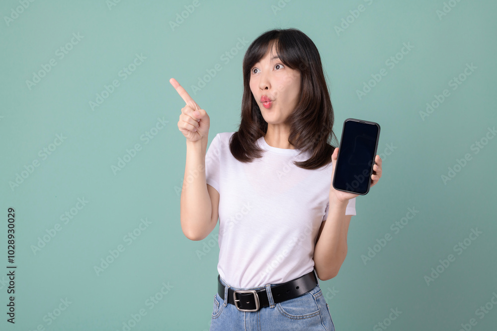 Woman holding phone and looking surprised, dressed in white t-shirt and jeans. Woman holding phone and looking surprised, dressed in white t-shirt and jeans.