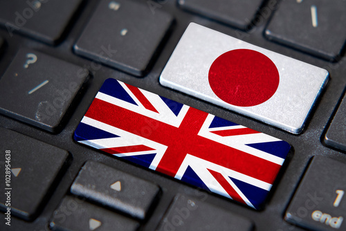 UK and Japan flags on computer keyboard photo