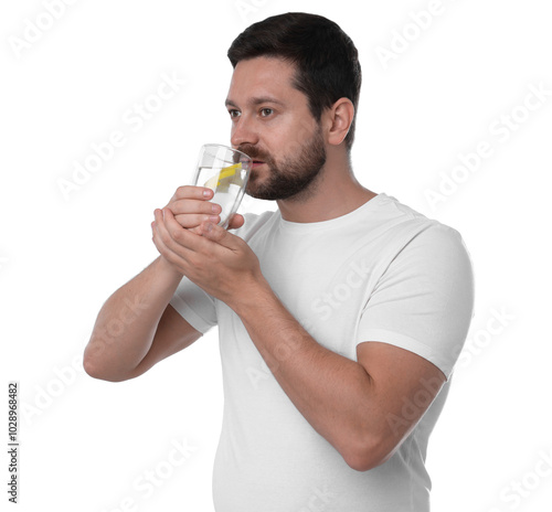 Handsome man drinking water with lemon on white background