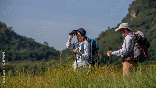 Family appears to be preparing for a hiking or camping expedition, as they are all equipped with backpacks, outdoor gear, and hat suggests an adventurous outdoor experience in holiday trip.