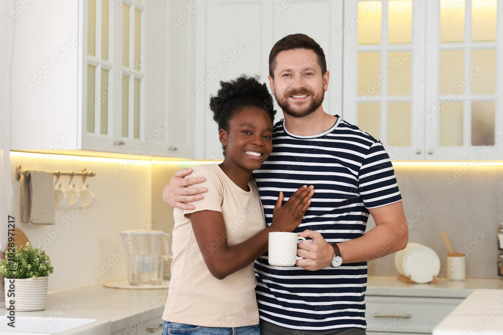 International relationships. Portrait of lovely couple in kitchen International relationships. Portrait of lovely couple in kitchen