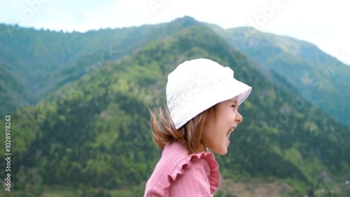 Happy child against the background of mountains. Traveling with a child