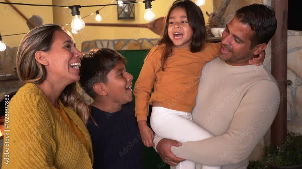 Happy latin family smiling in front of camera during winter season - Parents and children love concept
Happy latin family smiling in front of camera during winter season - Parents and children love concept