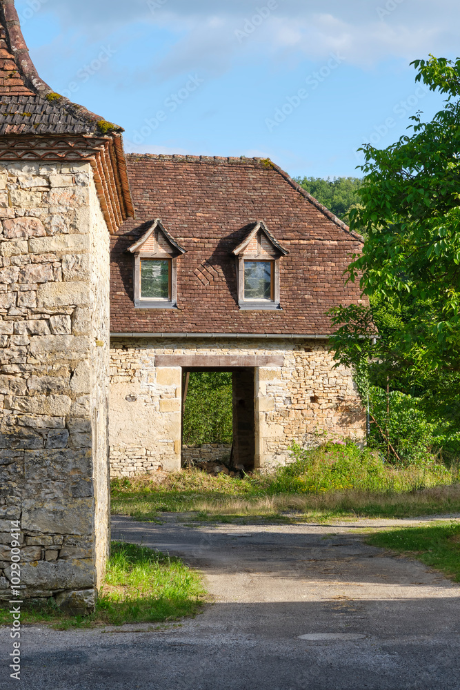 Empty natural stone farm house and barn in the last sunlight of the day in Cornac Lot Occitanie in Southern France Empty natural stone farm house and barn in the last sunlight of the day in Cornac Lot Occitanie in Southern France