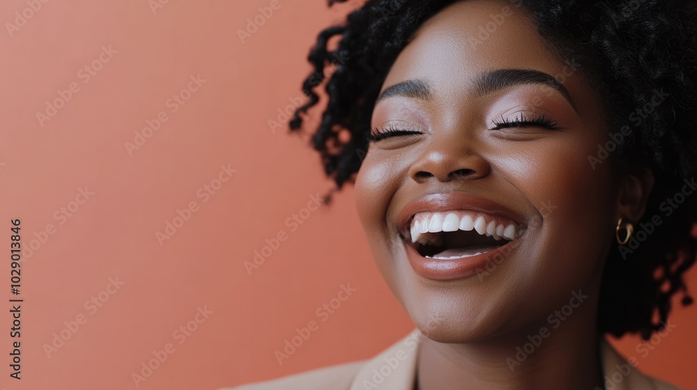 Close-Up Portrait of a Young Black Woman Laughing in Neutral Outfit Close-Up Portrait of a Young Black Woman Laughing in Neutral Outfit