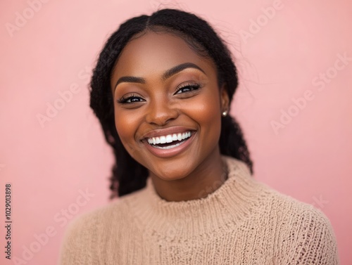 Close-Up Portrait of a Young Black Woman Laughing in Neutral Outfit photo