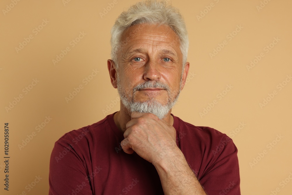 Portrait of senior man on beige background Portrait of senior man on beige background