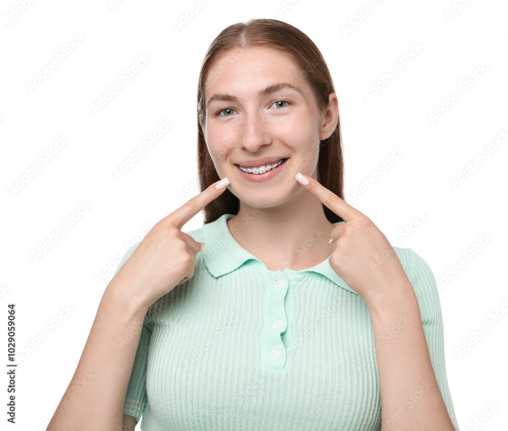 Smiling girl pointing at her braces on white background Smiling girl pointing at her braces on white background