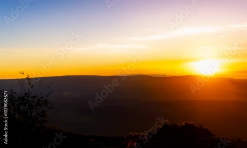 Wallpaper Mural A breathtaking sunset over a mountain range  with the sun casting a warm glow on the horizon.  Torontodigital.ca