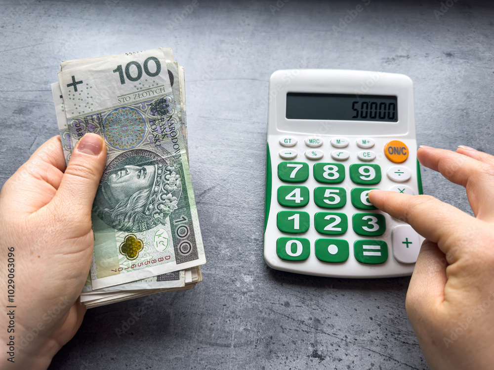 man count zloty and work with calculator. Business and financial concept PLN man count zloty and work with calculator. Business and financial concept PLN