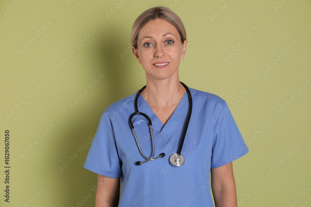 Portrait of nurse in medical uniform with stethoscope on light green background Portrait of nurse in medical uniform with stethoscope on light green background