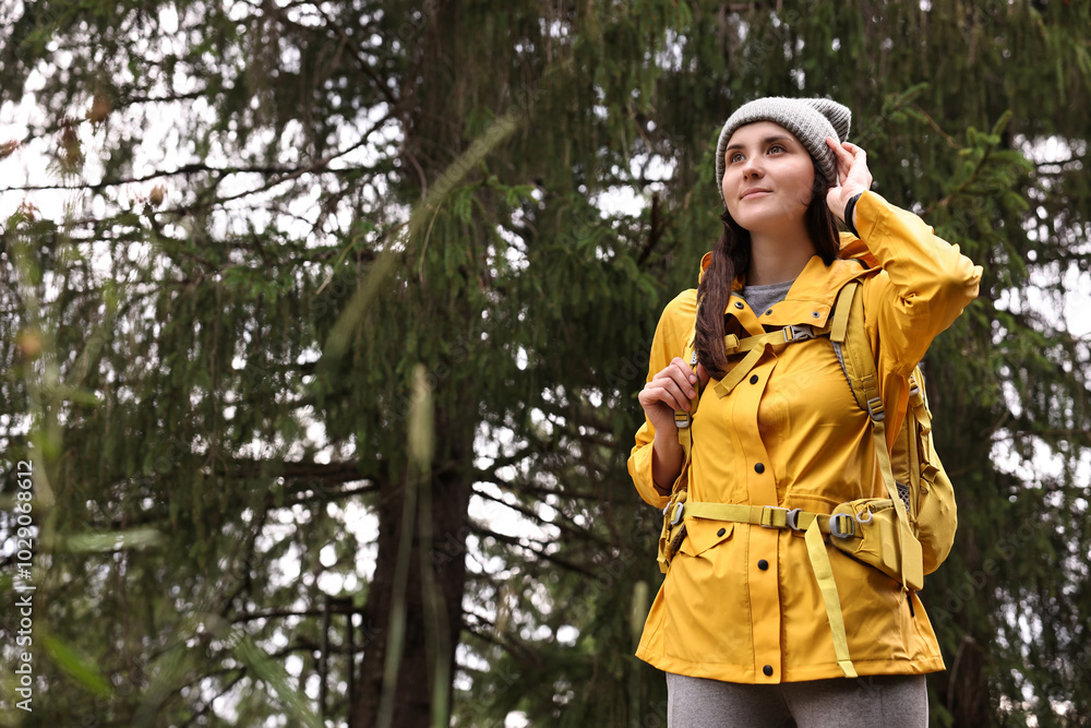 Young hiker with backpack in forest, space for text Young hiker with backpack in forest, space for text