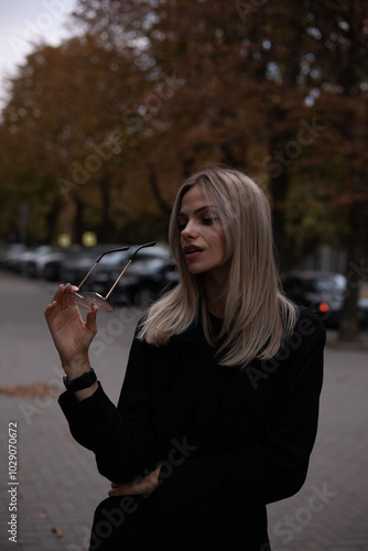 girl in glasses girl walking outside in autumn weather photo