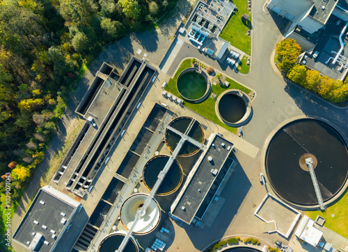 A view of a water treatment plant with several tanks and a large building