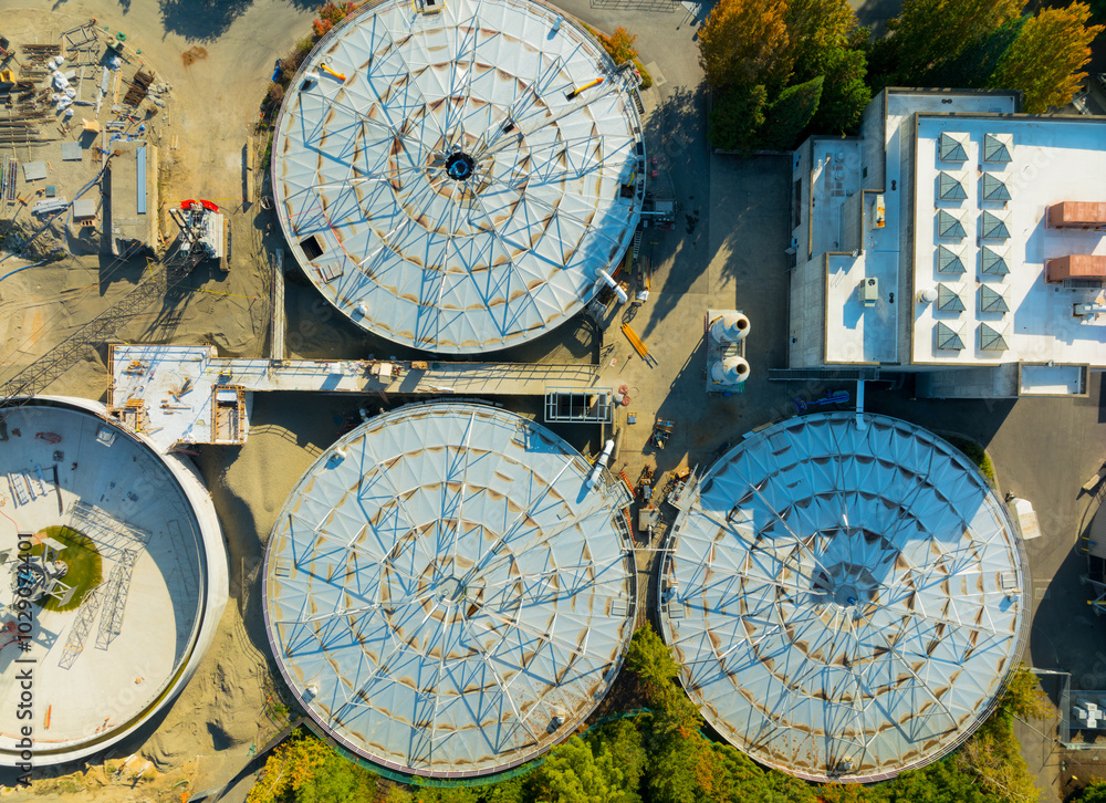 A view of a water treatment plant with three large tanks