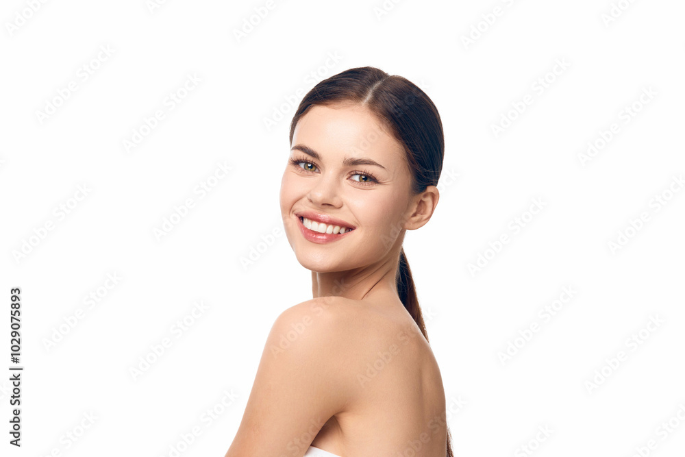 Happy woman with a towel on her head smiling against white background Happy woman with a towel on her head smiling against white background