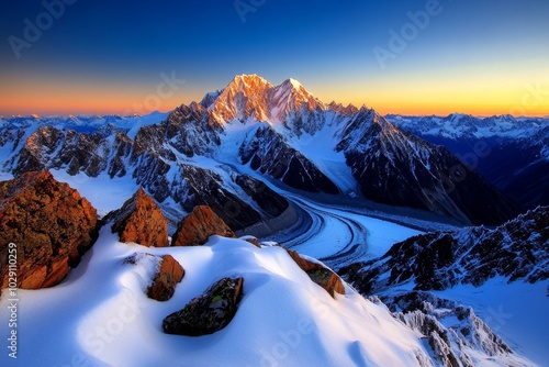 A snowy mountain range at sunset, with the peaks glowing in the fading light and the valley below covered in frost and snow, evoking the majesty of winter landscapes