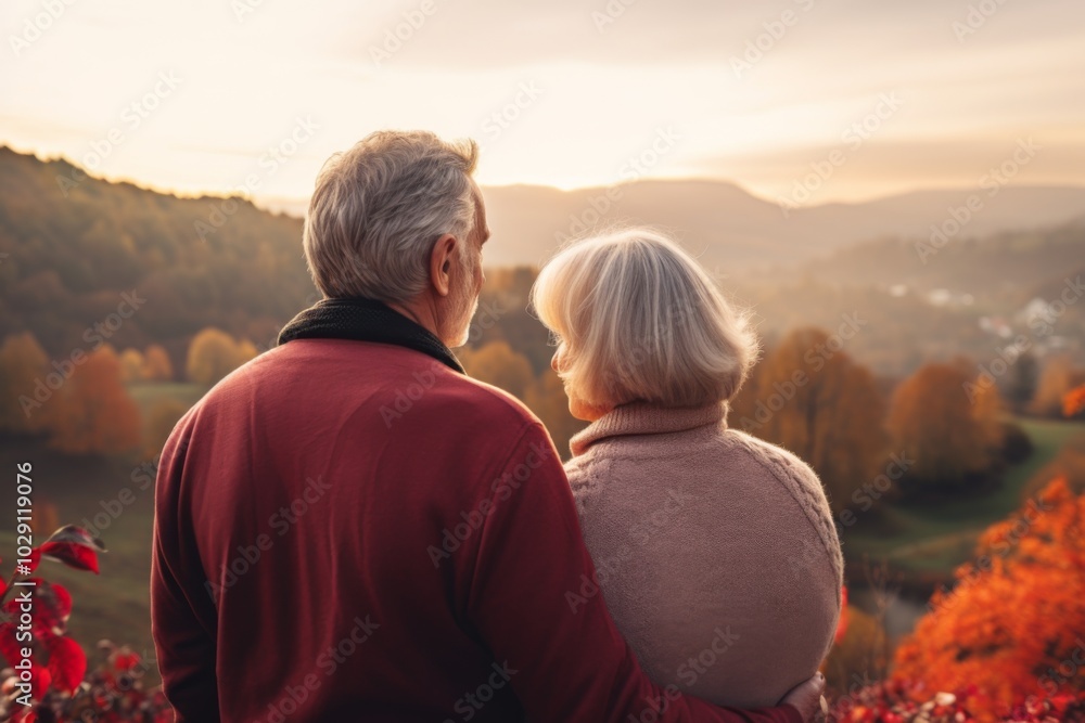 Rear view of a senior couple enjoying sunset view in nature Rear view of a senior couple enjoying sunset view in nature