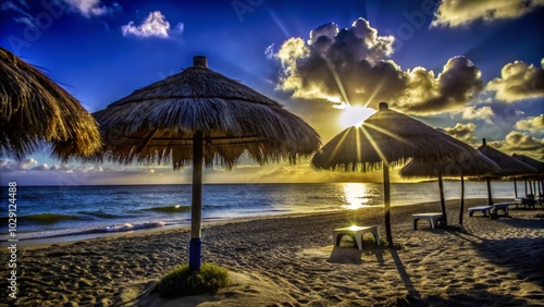 Fototapeta Naklejka Na Ścianę i Meble -  Relaxing Caribbean Beach with Thatched Umbrellas at Sunset - Perfect Vacation Spot