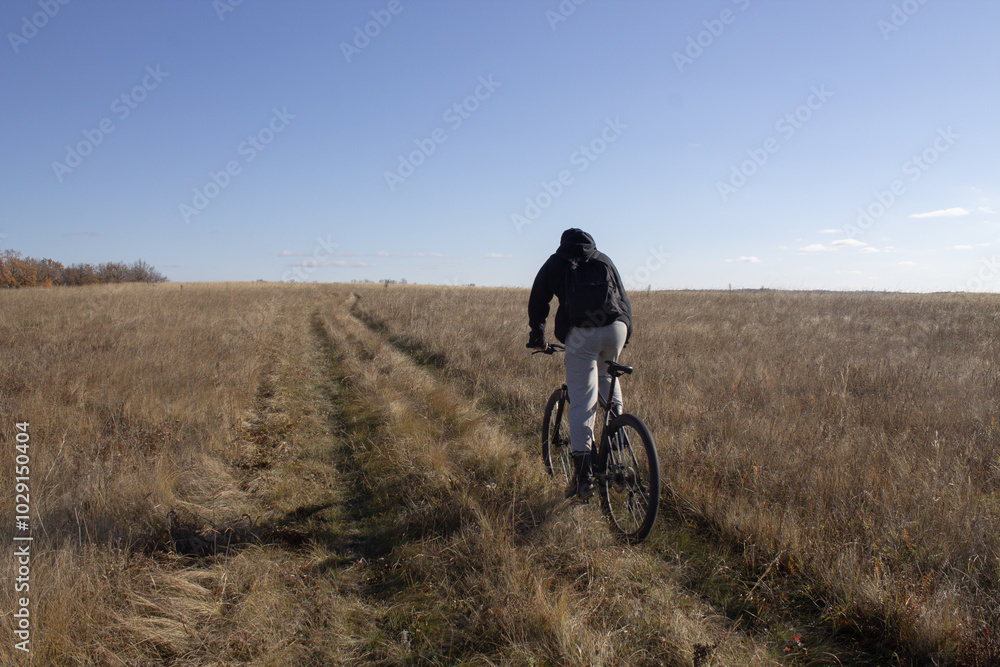 person riding a bicycle in the field person riding a bicycle in the field