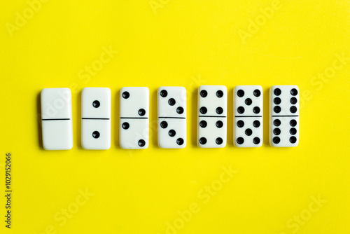 Domino tiles on yellow background.