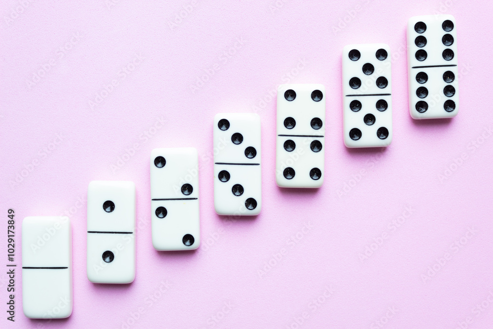 Domino tiles on pink background and space for text. Domino tiles on pink background and space for text.