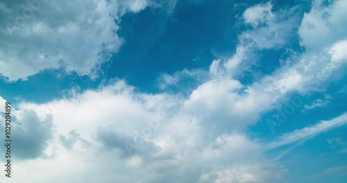 Timelapse of white puffy clouds in the blue sky