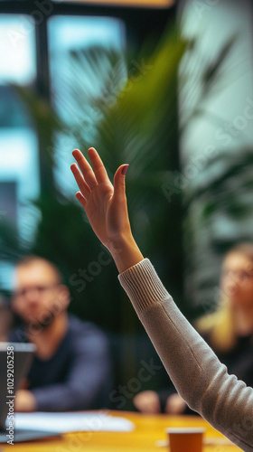 Wallpaper Mural An office worker raising their hand to speak during a meeting Torontodigital.ca