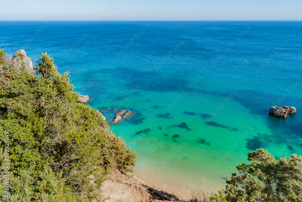 Aerial view of cliff with clear turquoise water at Ribeiro do Cavalo beach, Sesimbra PORTUGAL Aerial view of cliff with clear turquoise water at Ribeiro do Cavalo beach, Sesimbra PORTUGAL