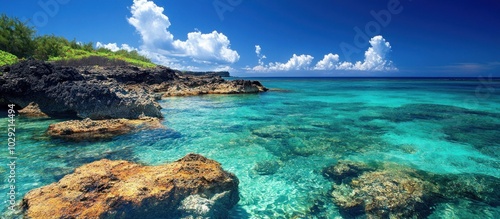 Tranquil turquoise water laps against rocky shores on a sunny day.