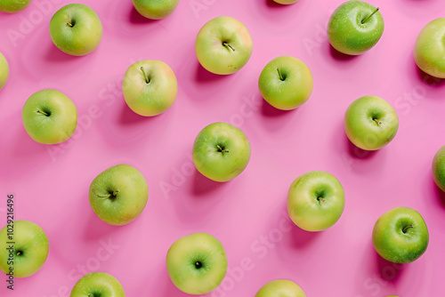 Ripe green apples on a pink background. Design template of fresh harvest, for backdrops, wallpapers, prints and textiles.