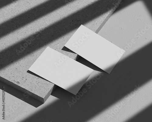 Bild auf Leinwand Left view two business card mockup on cement block and shadow overlay