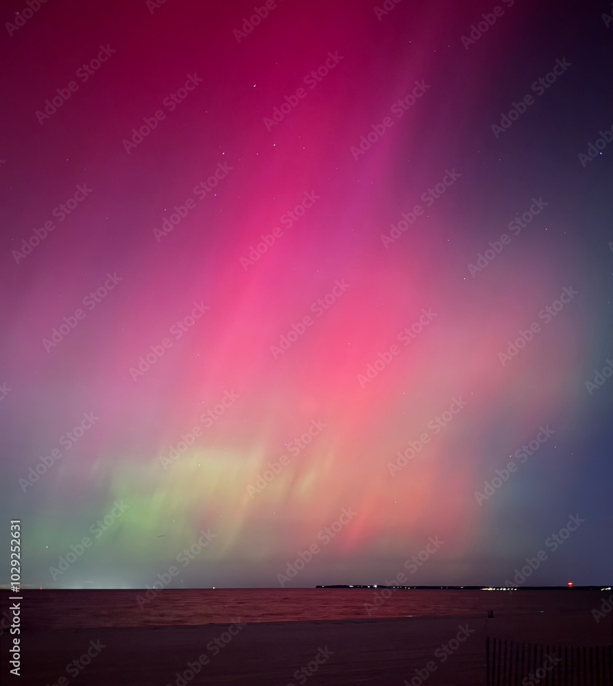 Stunning, dreamy display of vivid colors seen from aurora borealis, northern lights over Long Island, NY, 2024. The G4 geomagnetic storm dazzled over the beach for spectators in awe. Rare surreal Stunning, dreamy display of vivid colors seen from aurora borealis, northern lights over Long Island, NY, 2024. The G4 geomagnetic storm dazzled over the beach for spectators in awe. Rare surreal