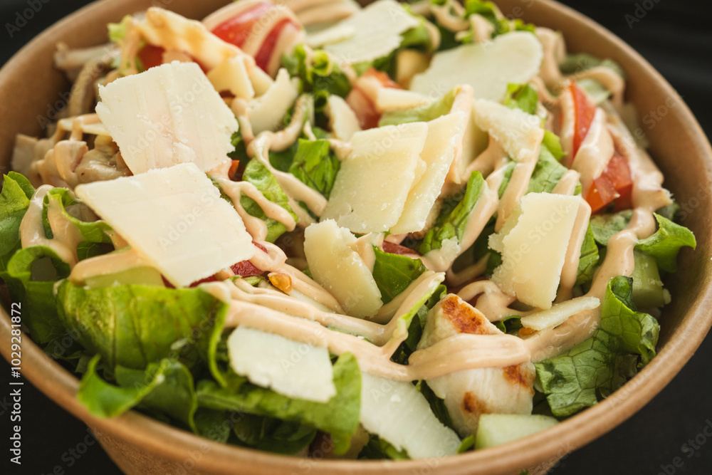 A close-up of a vibrant chicken salad featuring grilled chicken strips, fresh vegetables, and leafy greens, lightly dressed with vinaigrette. A close-up of a vibrant chicken salad featuring grilled chicken strips, fresh vegetables, and leafy greens, lightly dressed with vinaigrette.