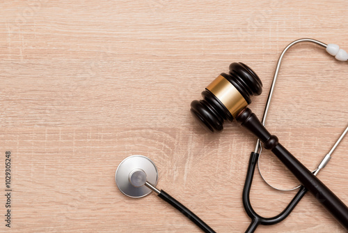 Judge gavel and stethoscope on wooden background, The law in medicine and medical negligence concept photo