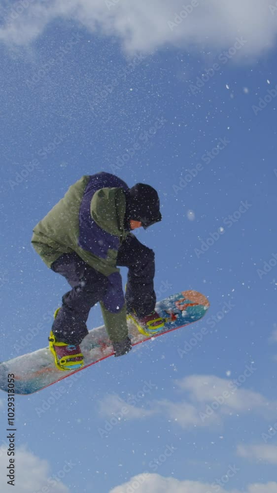 SLOW MOTION CLOSE UP: Extreme snowboarder jumping big air kicker in sunny winter in mountain snow park SLOW MOTION CLOSE UP: Extreme snowboarder jumping big air kicker in sunny winter in mountain snow park