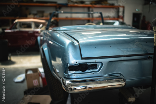 Classic cars being restored in a vintage vehicle garage workshop